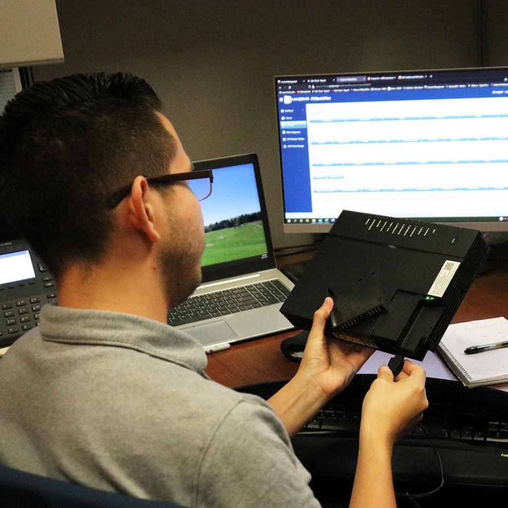 A Lakeland employee plugs in a router