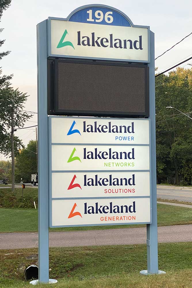 A photo of the sign in front of Lakeland Holdings' office in Bracebridge, with the logos of Lakeland Power, Lakeland Networks, Lakeland Solutions and Lakeland Generation