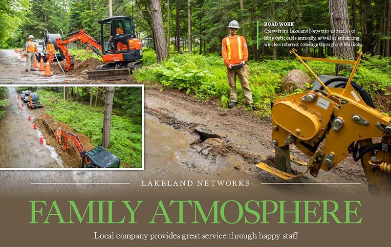 An image from the magazine article showing Lakeland employees using machines to dig a trench in a dirt road, with a background of trees. Text reads "Family Atmosphere, Local company provides great service through happy staff."
