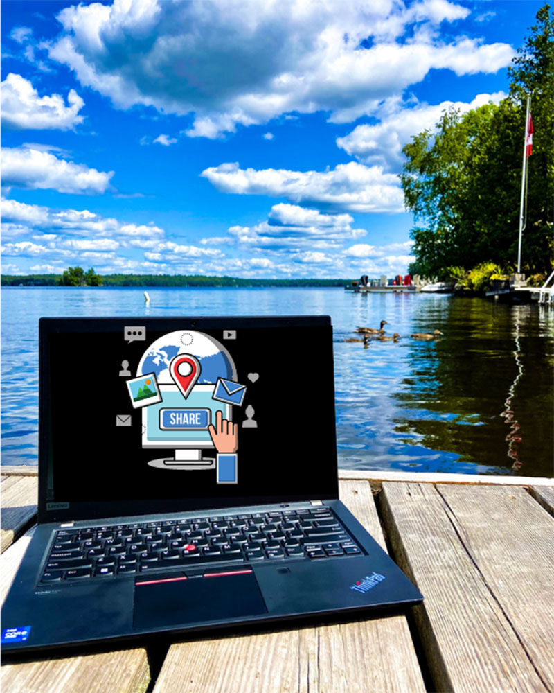Laptop sitting on a Muskoka dock.