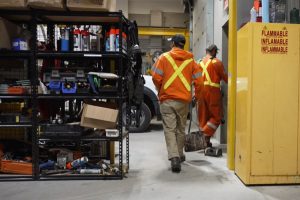 2 Lakeland technicians walking through a garage before they head out to a service call.