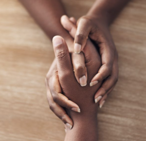 Close shot of two friends holding hands