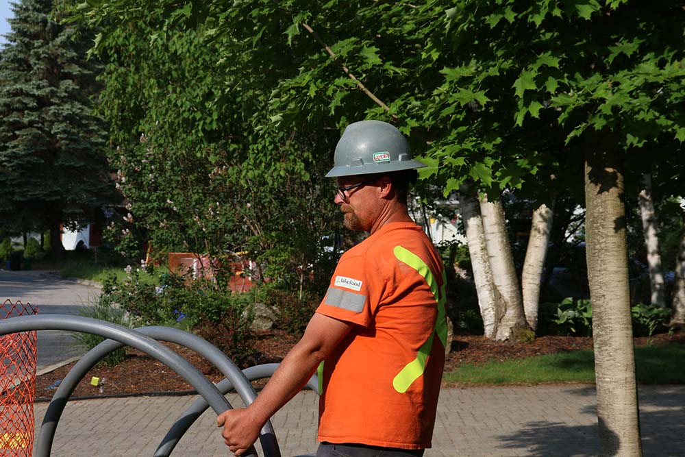 Lakeland worker carrying material in the sun